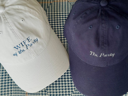 White hat "Wife of the Party" and navy hat "The Party"