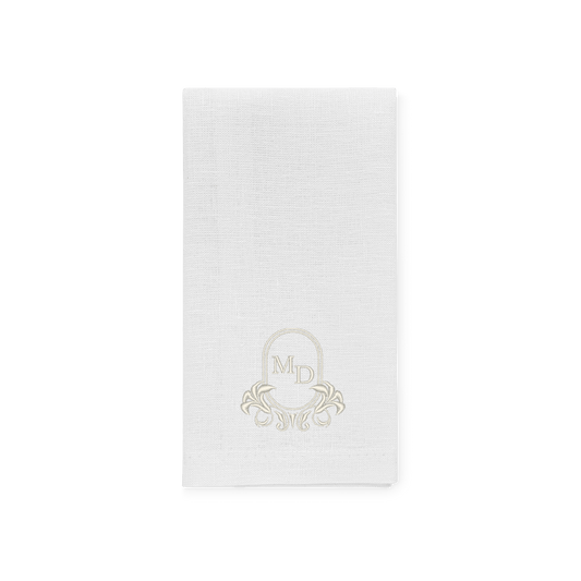 White linen napkin with crest and initials